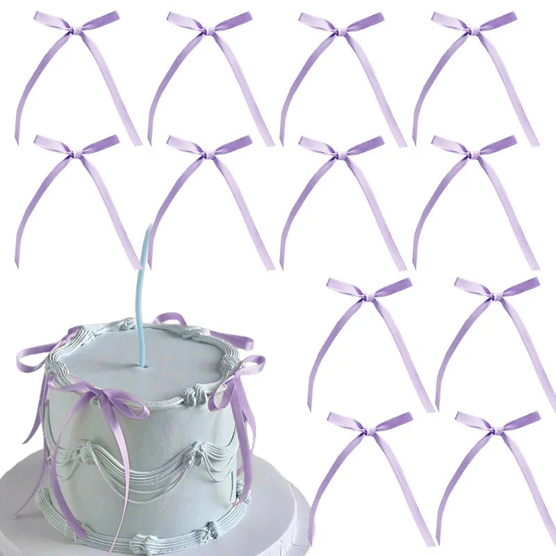 A set of twenty light purple bowknot ribbon cake toppers arranged around a white cake.