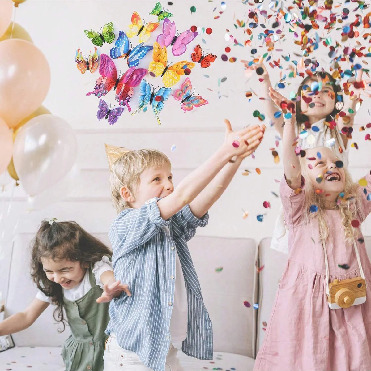 Three children joyfully interact with a set of 3D magnetic butterfly wall decor