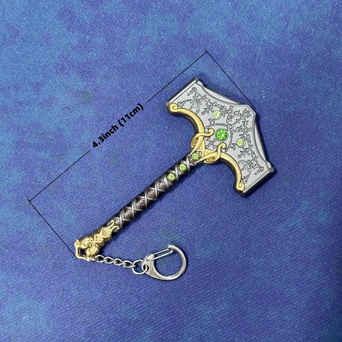 A miniature collectible sword resembling a Katana with a decorative hilt and chain, shown against a dark blue background.