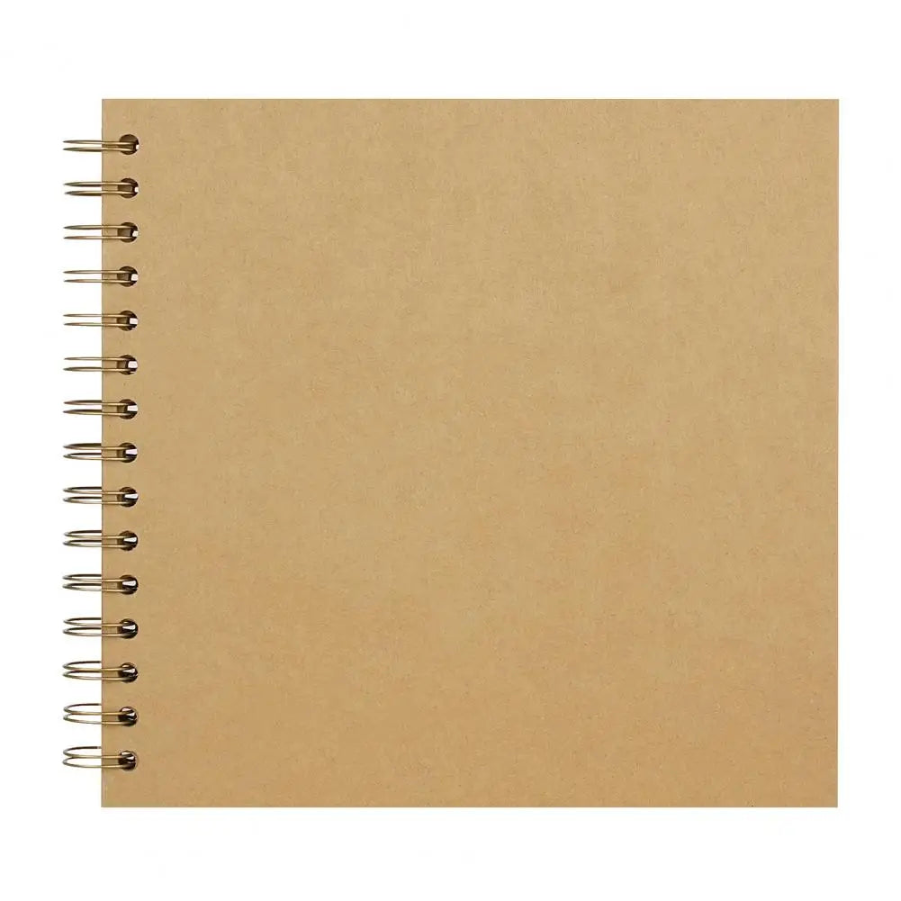 A blank tan spiral-bound notebook or scrapbook album with metal rings on the left edge.