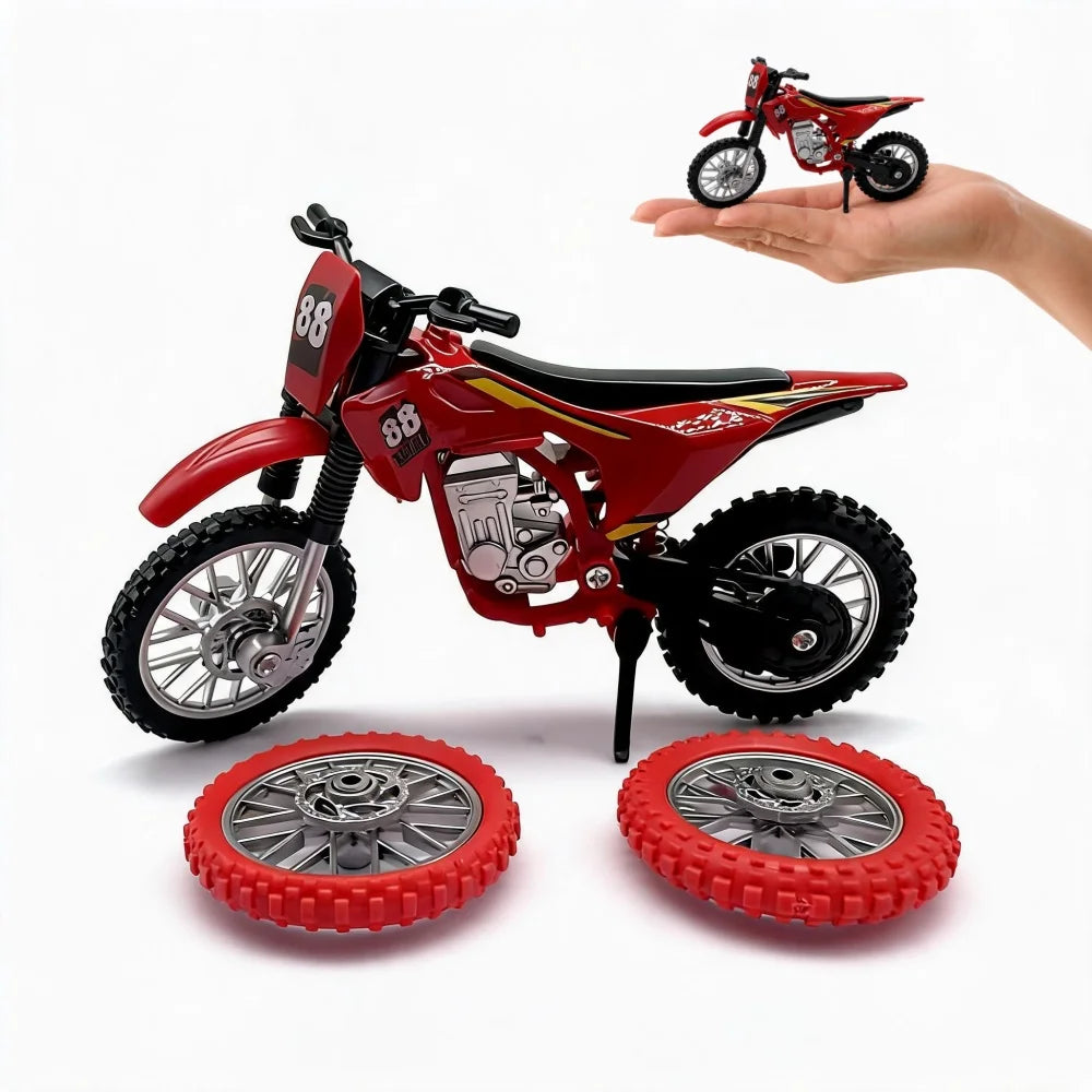 A red 1:12 scale off-road motorcycle model with spare wheels is held in a hand, alongside the separate wheels.