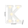 A white alphabet letter K light with warm white LED illumination.