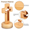 A handcrafted wooden cross standing ornament made of light wood with a smooth surface and rounded corners.