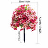 A dense ball of artificial pink and red flowers used as a topiary for outdoor planters.