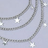 Silver Y2K star charm layered necklace featuring multiple chains and star pendants