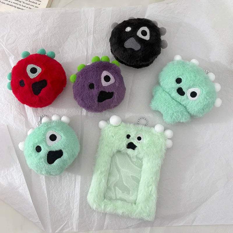 A collection of fuzzy plush keychains in various colors including red purple green and black on white paper