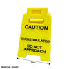 A bright yellow plastic desk sign with black text warning caution and do not approach.