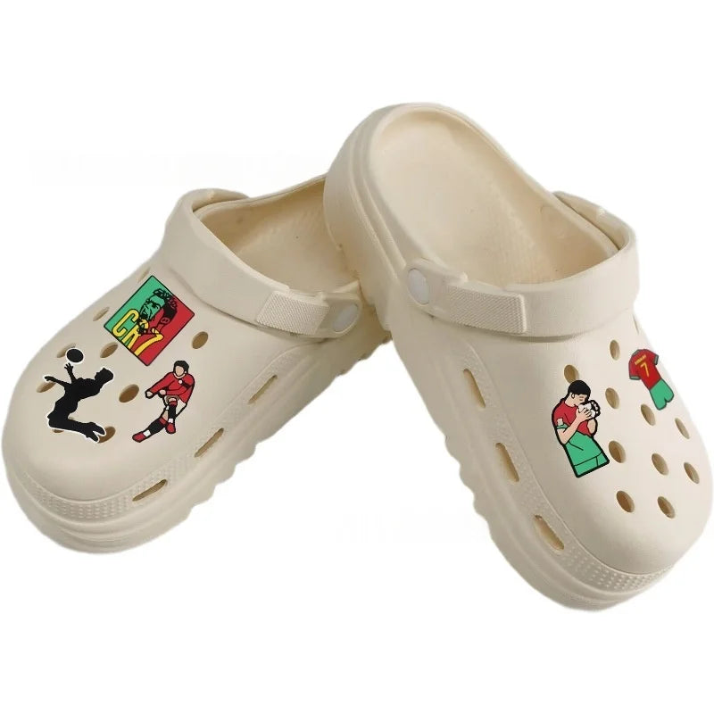 A pair of beige cartoon football shoe charms for classic clogs.