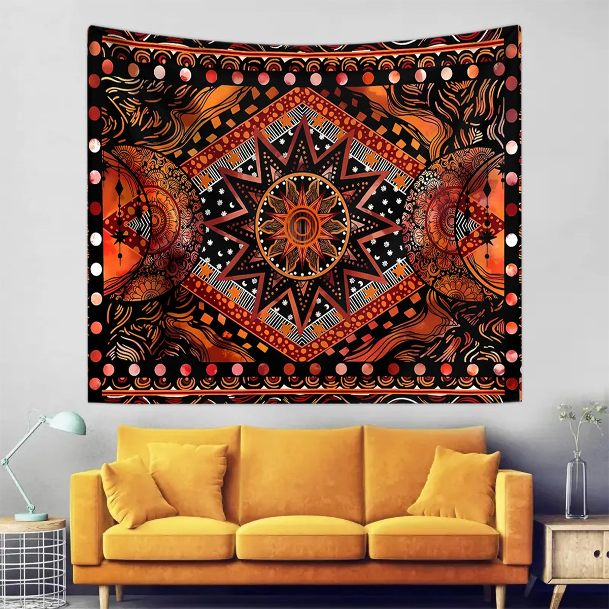 Bohemian sun and moon tapestry wall hanging featuring intricate orange, black, and gold patterns.