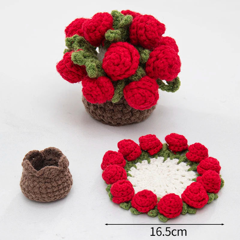 A hand-crocheted arrangement of red and green rose flowers used as coasters.