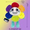 A colorful plush toy with a round body, large head, and various colored appendages against a light background.