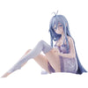 A figurine of an anime girl with blue hair sitting pose in a purple dress.