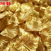 A pile of golden silk rose petals used for weddings and events.