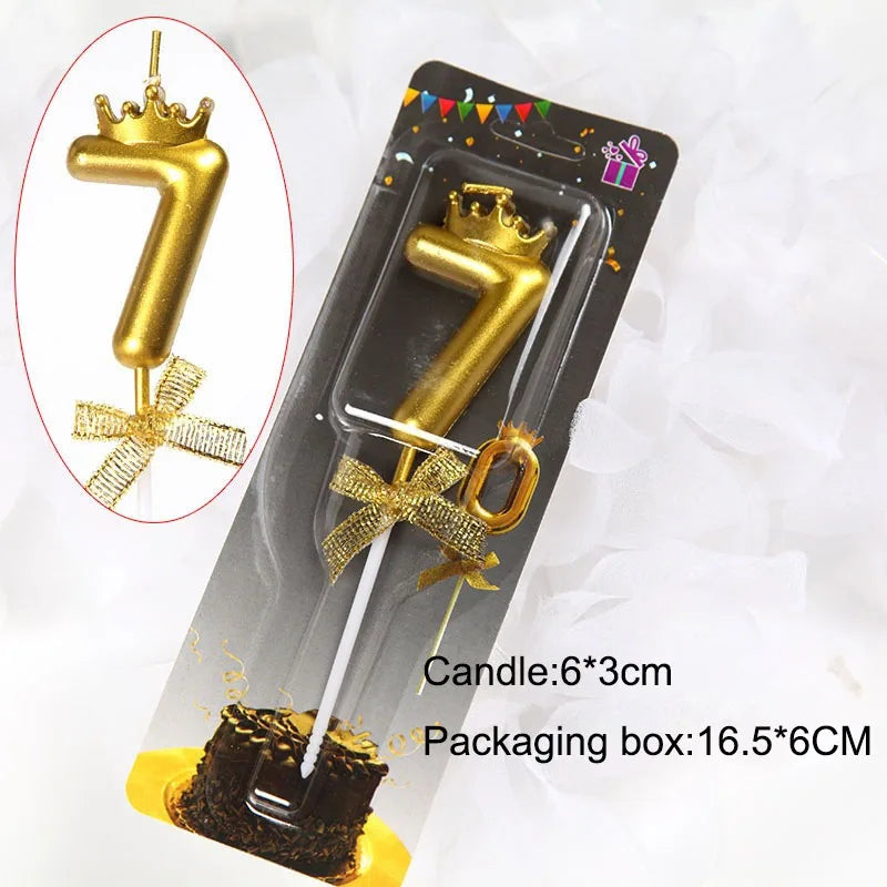 A gold number 7 candle with a crown topper and ribbon, packaged in a box for birthdays and celebrations.