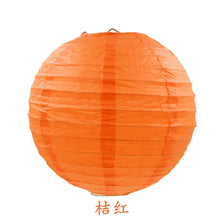 An orange round paper lantern used for parties and weddings.