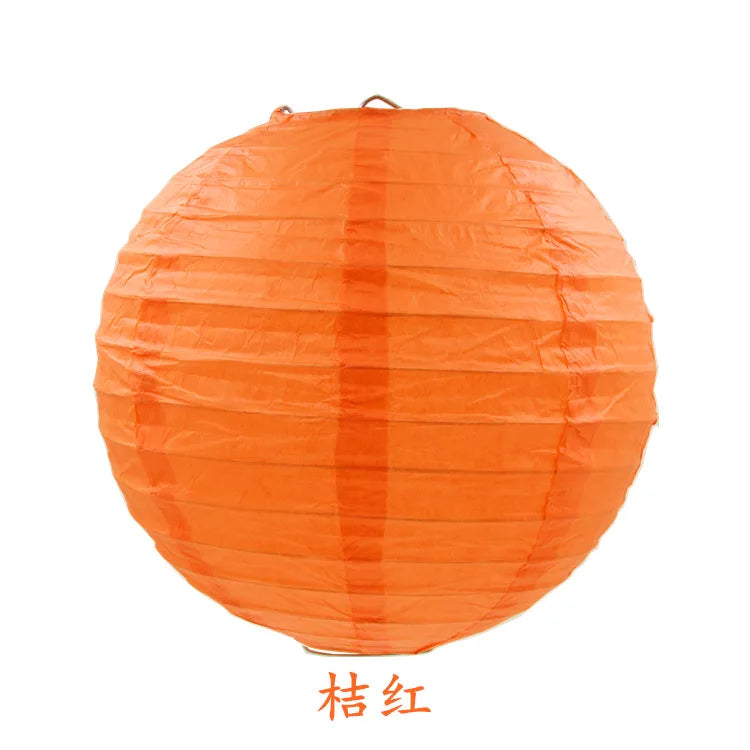 An orange round paper lantern used for parties and weddings.