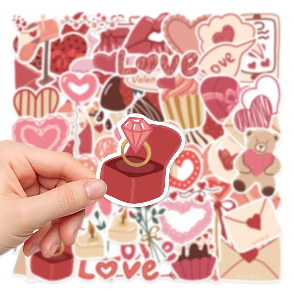 A hand holds a sheet of pink and red love-themed decorative stickers featuring hearts, roses, and other romantic elements.