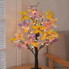 A decorative tree light featuring numerous butterfly-shaped lights in yellow, pink, and purple hues.