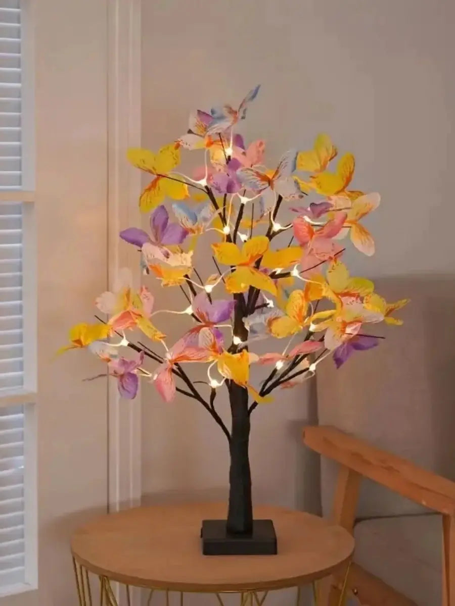 A decorative tree light featuring numerous butterfly-shaped lights in yellow, pink, and purple hues.