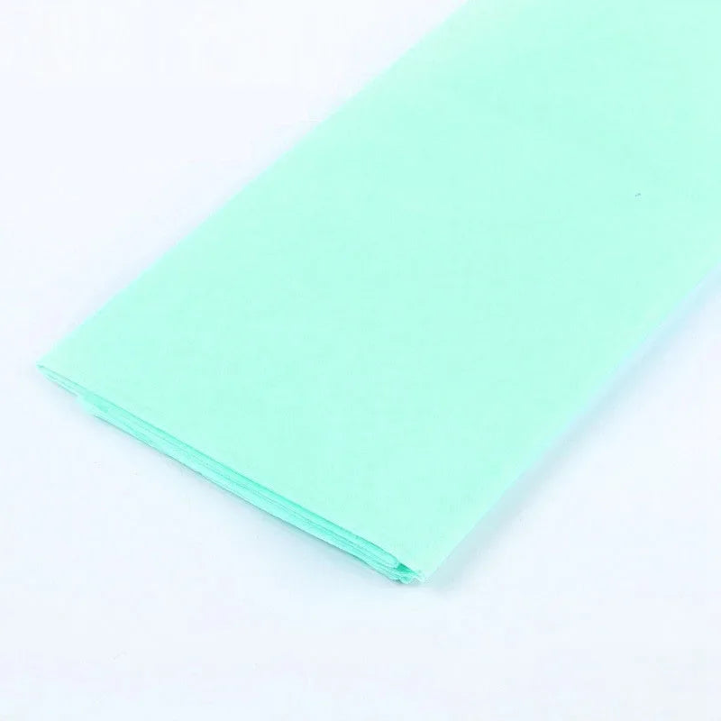 A sheet of light mint green soft tissue paper for gift wrapping and DIY crafts.