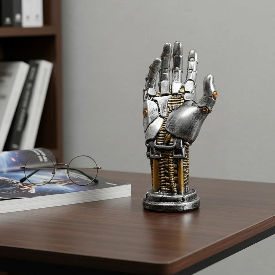 A metallic hand-shaped storage organizer for a 3D gamepad or controller, resting on a wooden surface.