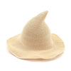 A beige vintage knit witch hat with a wide brim and pointed crown.