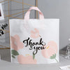 White floral thank you gift bags with pink and green watercolor designs