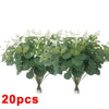 A bunch of artificial eucalyptus stems with realistic green leaves used for home decor or wedding centerpieces.