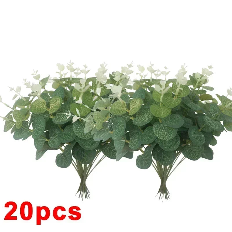 A bunch of artificial eucalyptus stems with realistic green leaves used for home decor or wedding centerpieces.