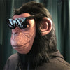 A person wearing a latex monkey mask costume with dark sunglasses and long black hair.