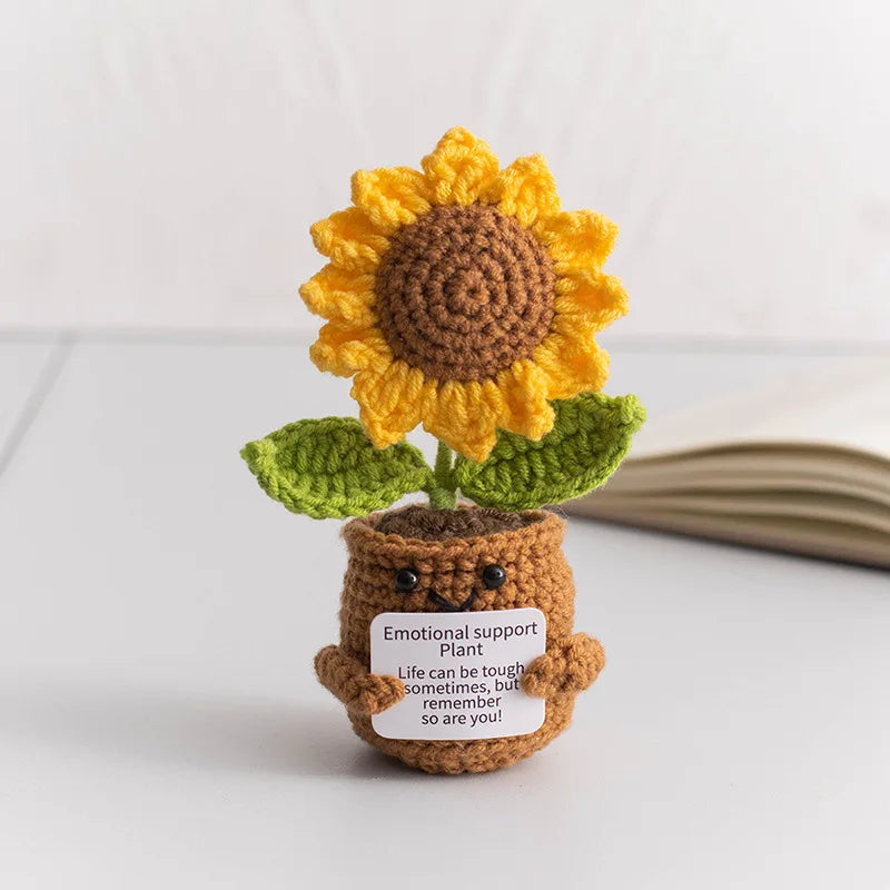 Handmade crochet sunflower desk companion with a smiling face, featuring yellow petals and a brown center.