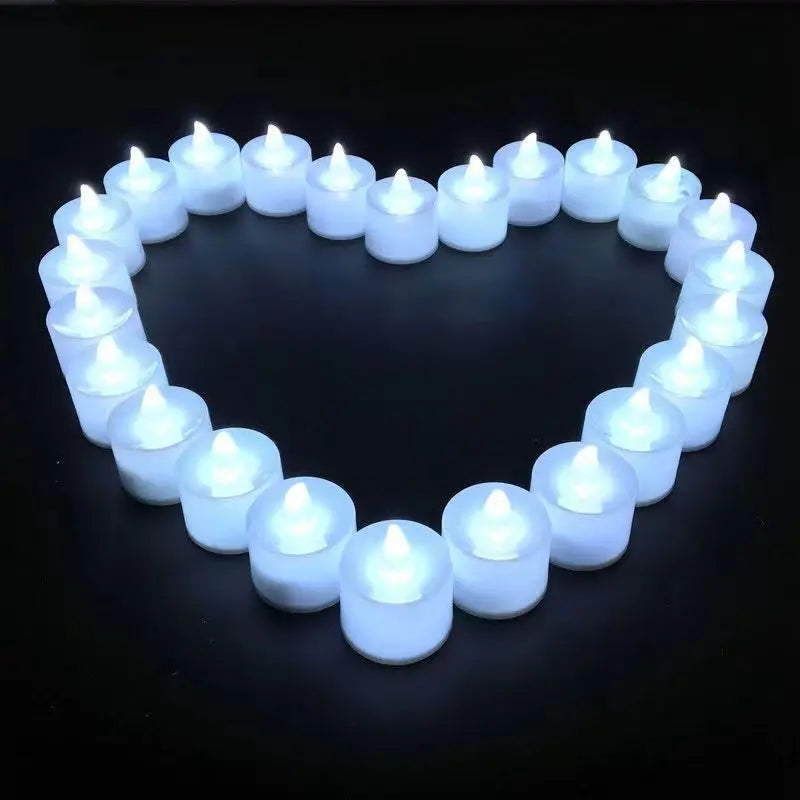 A heart shape formed by a ring of white LED tea light candles