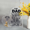 A clear heart-shaped glass sign engraved with the message to my dad I love you always and forever surrounded by yellow flower