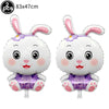 Two white bunny foil balloons with purple accents and pink ears