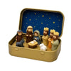 A nativity scene figurine set featuring figures and an animal displayed inside a gold storage box with a blue starry backgrou