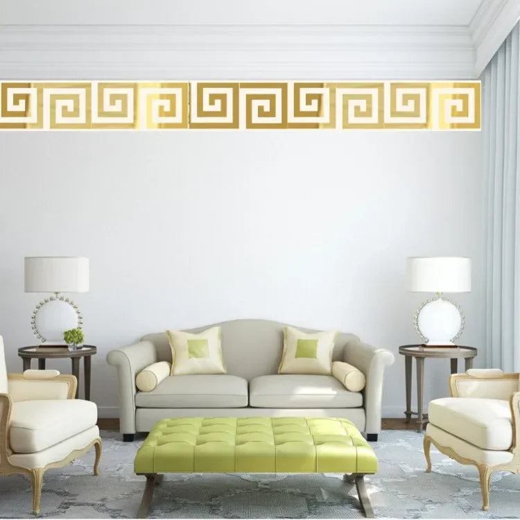 A living room features a light gray sofa, a lime green ottoman, and a gold decorative mirror trim on the white wall.