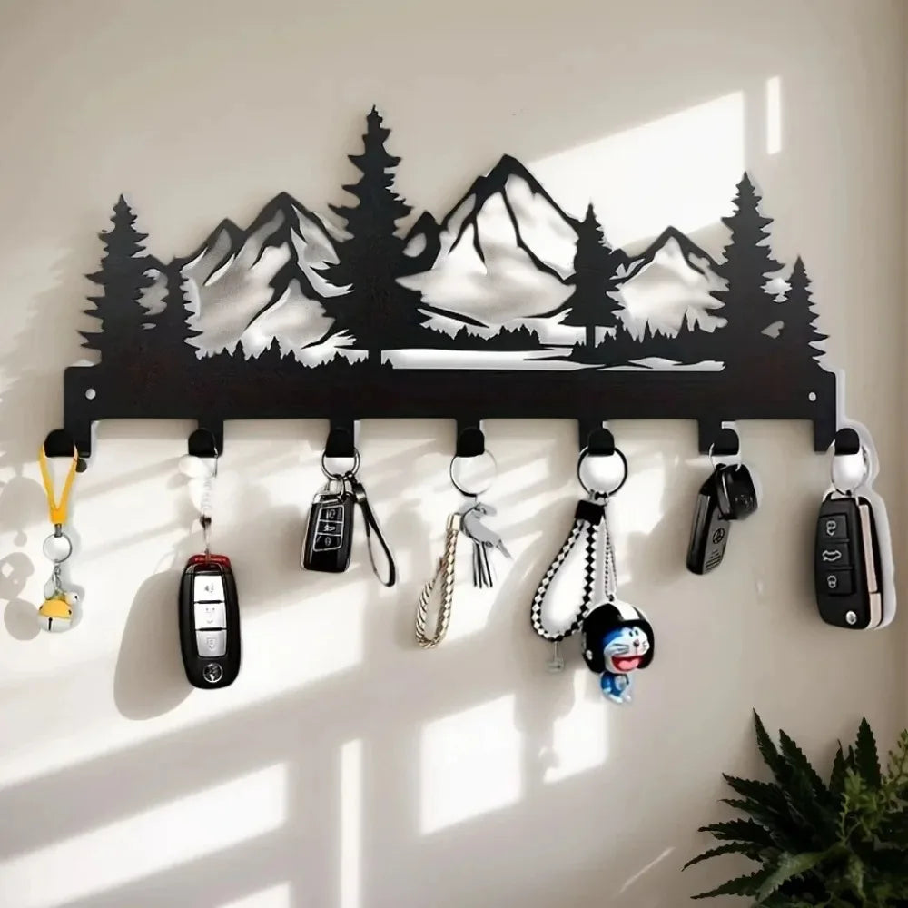 Black industrial iron wall mount key holder with seven hooks displaying various keys and charms.