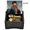 A hand-cranked wooden music box featuring an illustration of a woman and a bird, with internal brass components.