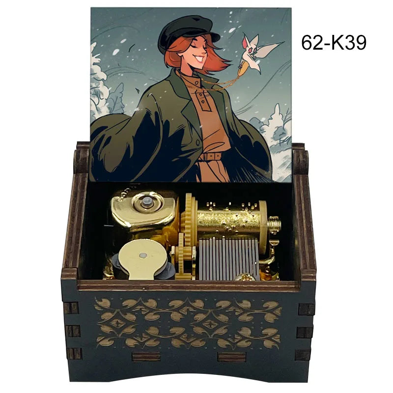 A hand-cranked wooden music box featuring an illustration of a woman and a bird, with internal brass components.