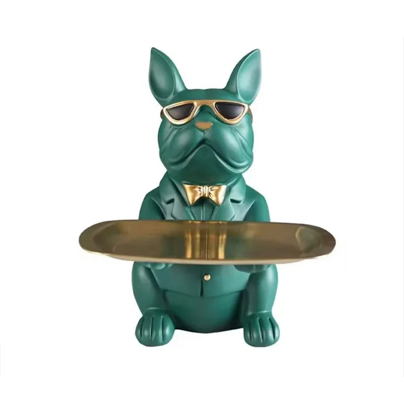 A green bulldog statue wearing sunglasses sitting behind a gold tray.