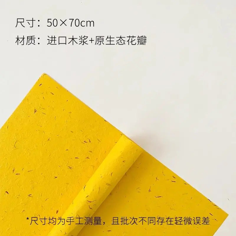 Yellow decorative packaging paper rolled up, featuring a texture resembling flower petals.
