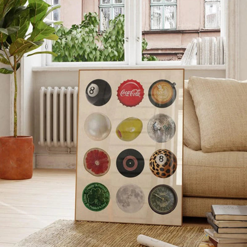 A framed collage of various vintage 8 ball designs and circular patterns displayed in a light wooden frame.