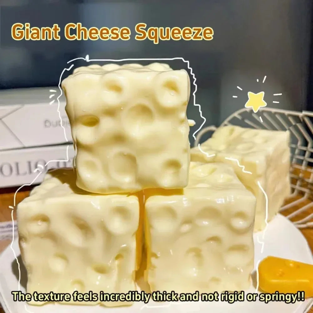 A close-up of giant cheese squishy toys showing thick, soft texture in white and yellow colors.