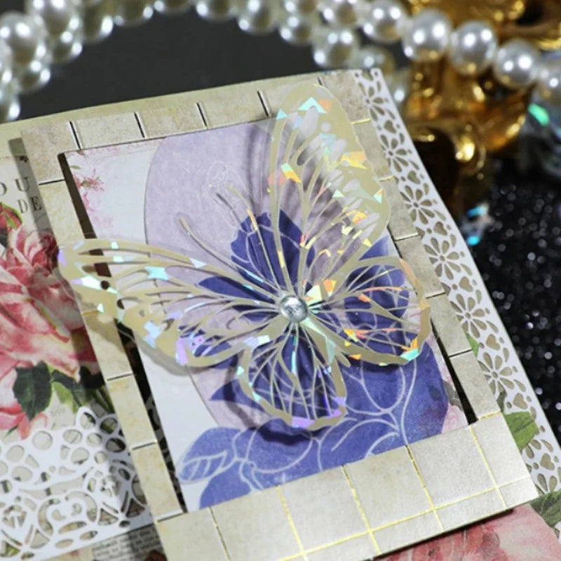 A clear iridescent butterfly sticker is displayed on a light kraft paper background.