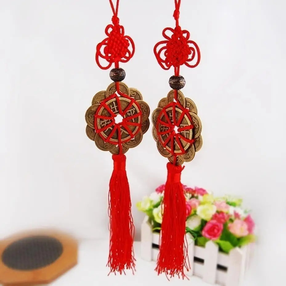 Red and gold mystic knot wall decor featuring tassels and circular designs
