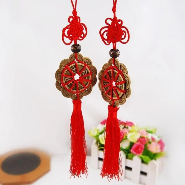 Red and gold mystic knot wall decor featuring tassels and circular designs