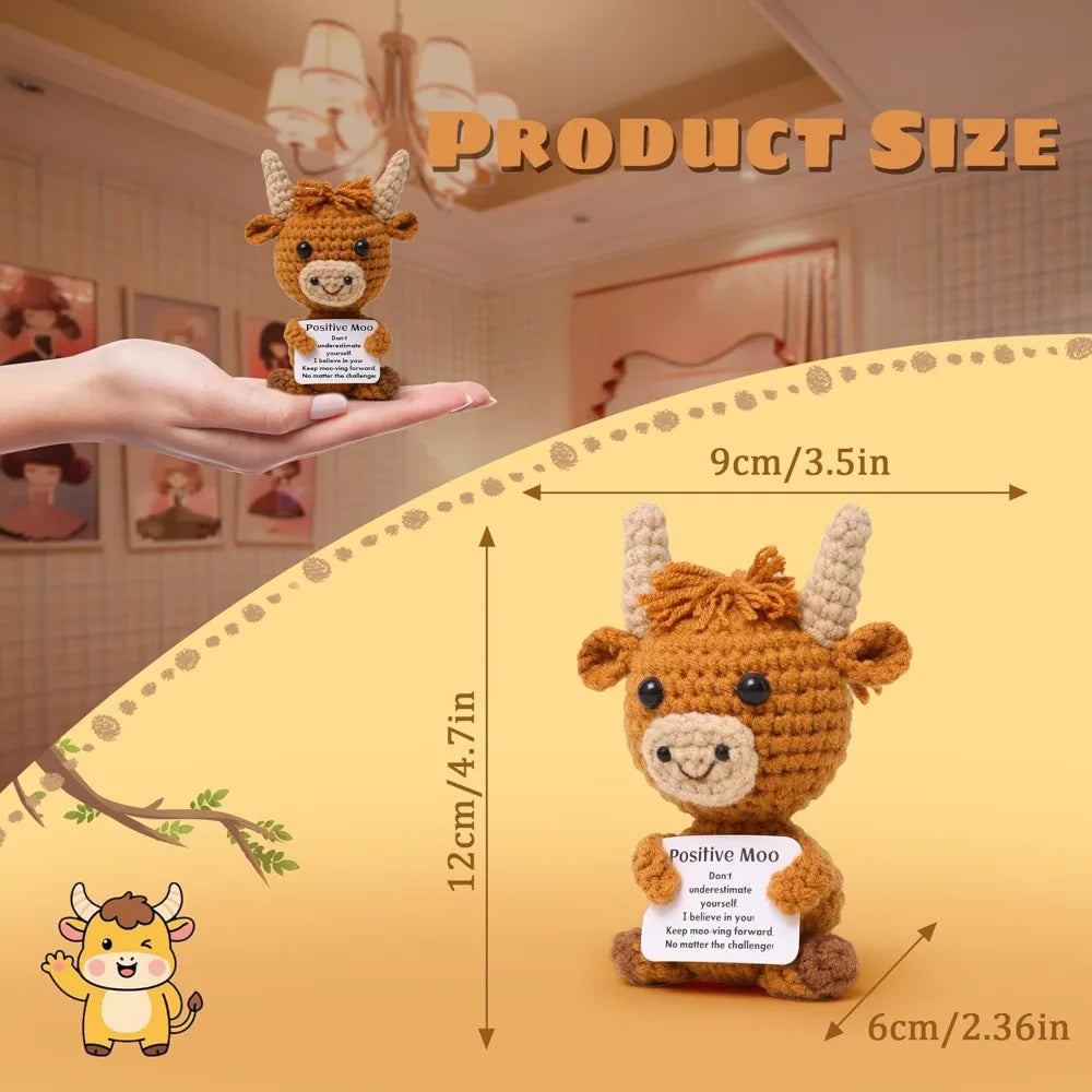 A crocheted Highland cow keepsake is shown next to a hand, with size measurements provided.