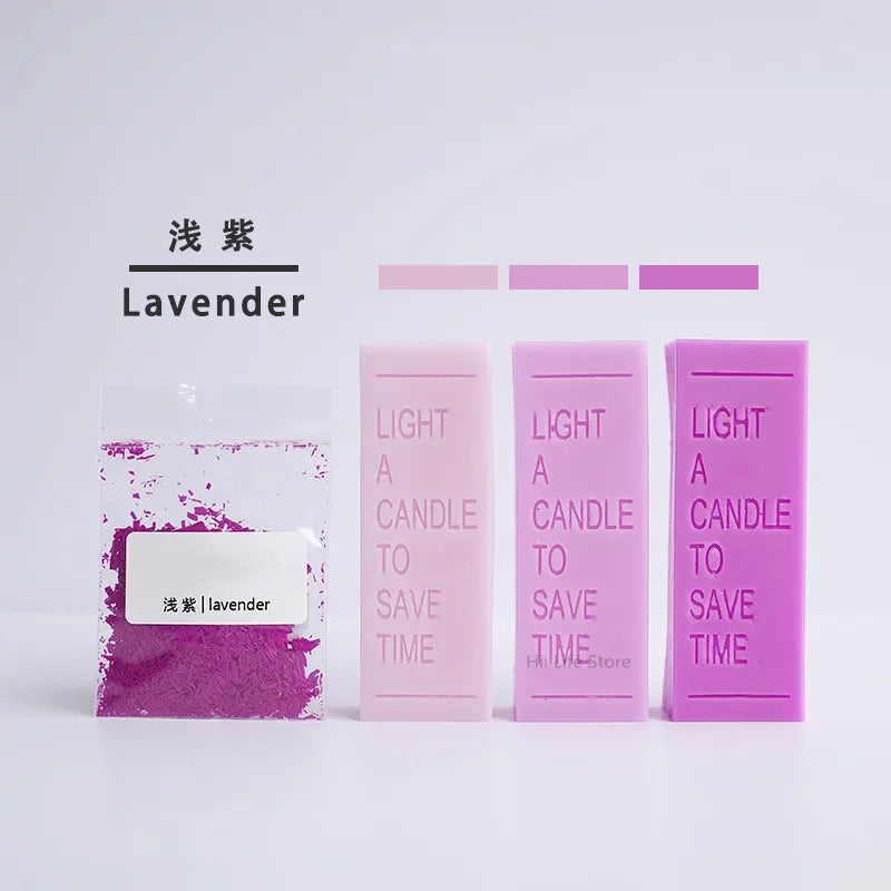 Lavender flower petal dye colorants in various shades of purple and pink displayed next to a lavender candle product.