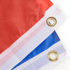 A close-up of a red and white flag banner with blue stripes, featuring grommets for hanging.