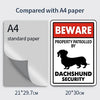 Comparison of an A4 paper size to a 20x30 cm sign featuring a Dachshund security theme.